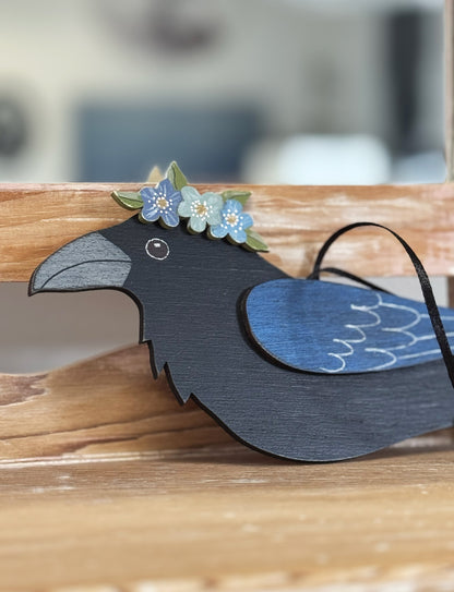 RAVEN WITH BLUE FLORAL CROWN — Hand-Painted Wooden Raven Hanging